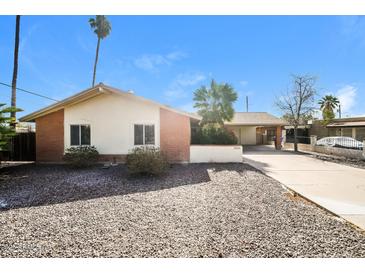 Charming single-story home featuring desert landscaping and a covered carport on a bright, sunny day at 2643 E Virginia Ave, Phoenix, AZ 85008