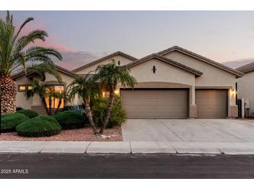 Charming single-story home featuring a spacious three-car garage, desert landscaping, and neutral color palette at 3887 E Andre Ave, Gilbert, AZ 85298