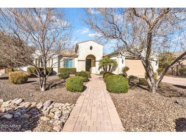 Charming single-story home featuring desert landscaping, a paved walkway, and an arched entryway at 4926 S Hemet St, Gilbert, AZ 85298