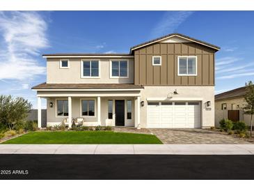 Beautiful two-story home featuring a two-car garage, covered front porch and well-manicured lawn at 5711 S Quartz St, Gilbert, AZ 85298