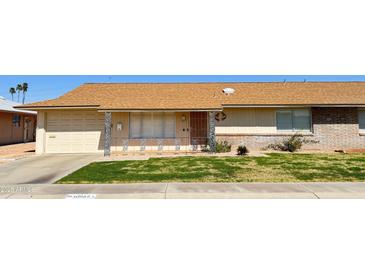 Charming single-story home featuring a well-manicured front yard and attached garage at 10562 W Campana Dr, Sun City, AZ 85351