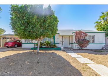 Charming single-story home with a well-maintained front yard and mature landscaping, offering great curb appeal at 1217 E Edgemont Ave, Phoenix, AZ 85006