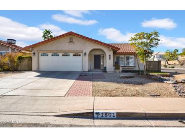 Charming home featuring a well-maintained front yard and a two-car garage at 1801 E Hearn Rd, Phoenix, AZ 85022