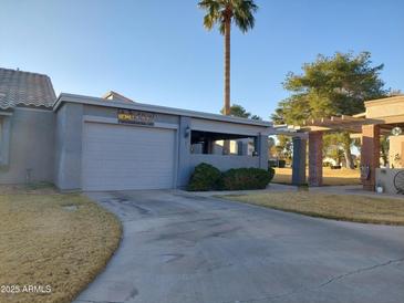 Charming single-story home with a private driveway, desert landscaping, and a covered patio area at 276 Leisure World --, Mesa, AZ 85206