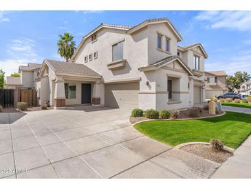 Two-story home featuring a three car garage, desert landscaping, and a welcoming entrance at 3794 S Laurel Way, Chandler, AZ 85286