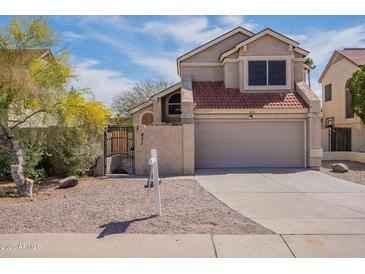 Charming two-story home featuring a red tile roof and a well-maintained front yard at 433 E Utopia Rd, Phoenix, AZ 85024