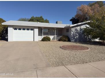Charming single-story home with a well-maintained front yard and attached two car garage at 5828 E Dallas St, Mesa, AZ 85205