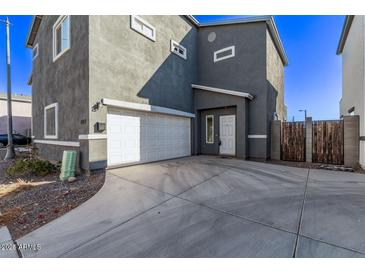 Two-story gray home with a white garage door and concrete driveway at 1017 E Odeum Ln, Phoenix, AZ 85040