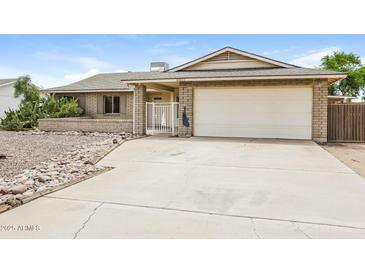 Charming one-story home featuring a well-manicured front yard and a two-car attached garage at 10822 N 47Th Ave, Glendale, AZ 85304