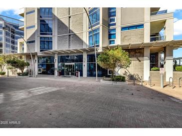 Modern building with a glass-covered entryway, beautiful foliage, and red brick pedestrian area at 120 E Rio Salado Pkwy # 101, Tempe, AZ 85281