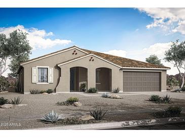 Charming single-story home showcasing a desert landscape, arched entryway, and attached two car garage at 17422 W Via Dona Rd, Surprise, AZ 85387