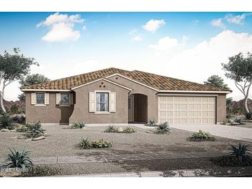 Charming single-story home with a tile roof, desert landscaping, and an attached two-car garage at 17450 W Via Dona Rd, Surprise, AZ 85387
