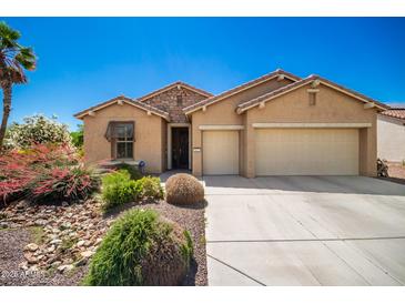 Charming single-story home with a well-maintained yard and a three-car garage at 1822 N 164Th Dr # 58, Goodyear, AZ 85395