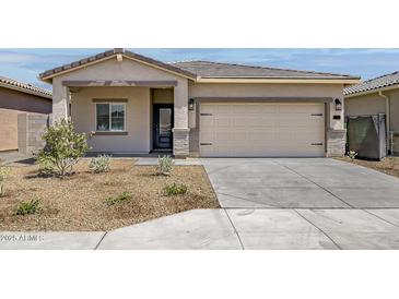 Charming single-story home featuring a spacious two-car garage and well-maintained landscaping at 24577 W St Anne Ave, Buckeye, AZ 85326