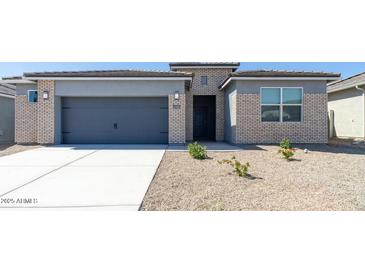 Charming single-story home featuring a two-car garage and low-maintenance desert landscaping at 2480 S 241St Ave, Buckeye, AZ 85326
