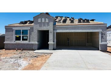 Unfinished exterior of a home under construction with stucco and dark roofing tiles at 28200 N Nealite Dr, San Tan Valley, AZ 85143