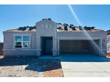 View of a one-story home with a stucco exterior and an attached garage in a new construction community at 28200 N Nealite Dr, San Tan Valley, AZ 85143
