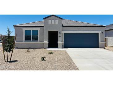 Charming single-story home featuring a well-manicured front yard, covered entryway, and attached two-car garage at 28200 N Nealite Dr, San Tan Valley, AZ 85143