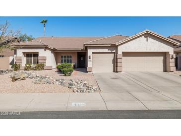 Charming single-story home featuring a two-car garage and low-maintenance desert landscaping at 4936 E Villa Rita Dr, Scottsdale, AZ 85254