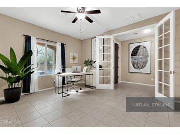 Bright home office with large windows, modern desk, stylish decor, and neutral wall paint at 5265 S Dante --, Mesa, AZ 85212