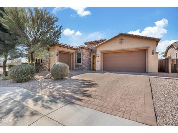 Charming single-story home featuring a three-car garage and well-manicured landscaping at 5334 S Parkwood --, Mesa, AZ 85212