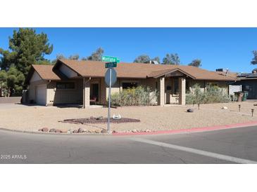 Charming single-story home with a well-manicured desert front yard and brick accents at 11406 W Montana Ave, Youngtown, AZ 85363