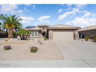 Charming single-story home with desert landscaping, a tile roof, and an attached two-car garage at 15542 W Cypress Point Dr, Surprise, AZ 85374