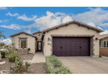 Charming single-story home featuring a two-car garage and desert landscaping at 1805 E Atole Pl, Queen Creek, AZ 85140