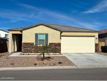 Charming single-story home featuring a two-car garage and well-maintained landscaping with desert accents at 18400 E Donato Dr, Gold Canyon, AZ 85118