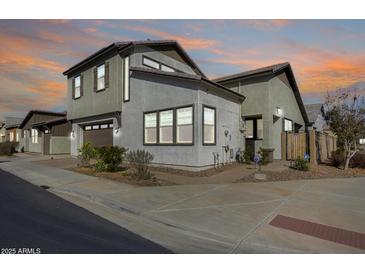 Well-maintained two-story home featuring neutral stucco, a two-car garage, and tidy landscaping at 1950 E Lantana Dr, Chandler, AZ 85286