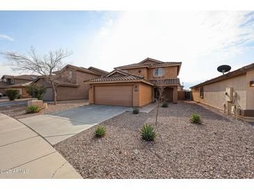 Charming two-story home with a two car garage and low maintenance desert landscaping at 22473 W Woodlands Ave, Buckeye, AZ 85326