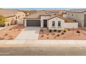 Charming single-story home featuring a well-manicured front yard, neutral color palette, and two car garage at 3287 N 197Th Ln, Buckeye, AZ 85396