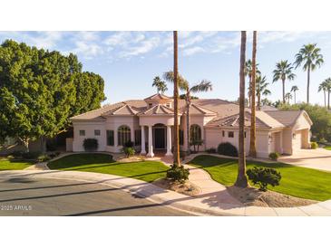 Stunning home showcasing a perfectly manicured front yard with an impressive circular driveway at 3441 S Camellia Pl, Chandler, AZ 85248