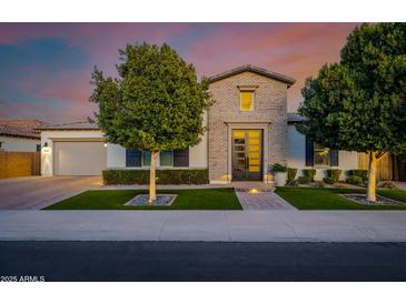 Charming home featuring brick accents, a multi-pane front door, manicured landscaping and mature trees at 4191 S Emerald Dr, Chandler, AZ 85249