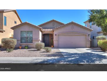 Charming single-story home featuring a well-maintained yard with desert landscaping and a two car garage at 42297 W Lunar St, Maricopa, AZ 85138