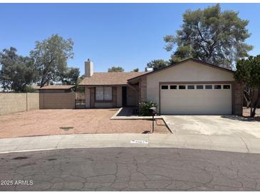 Charming home with desert landscaping, a two-car garage, and mature trees at 4927 W Golden Ln, Glendale, AZ 85302