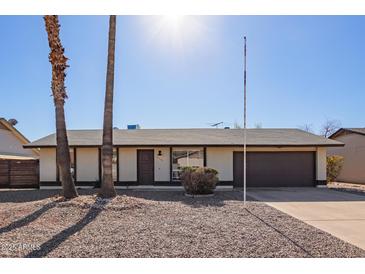 Charming single-story home with a gravel front yard and attached garage at 10533 W Lawrence Ln, Peoria, AZ 85345