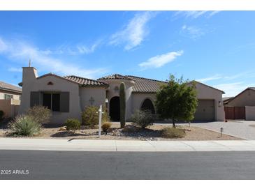 Charming single-story home featuring a stucco exterior, tile roof, and desert landscaping at 1319 N Chatsworth St, Mesa, AZ 85207