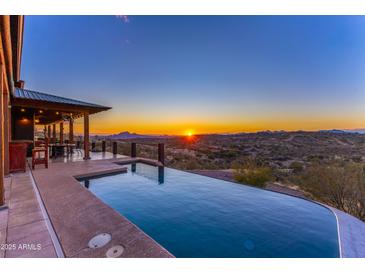 Relax by the infinity pool and enjoy breathtaking sunset mountain views from the patio at 14426 N Vista Del Oro --, Scottsdale, AZ 85264