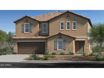 Charming two-story home featuring a tan stucco exterior, shuttered windows, attached two-car garage and desert landscaping at 17166 W Oberlin Way, Surprise, AZ 85387