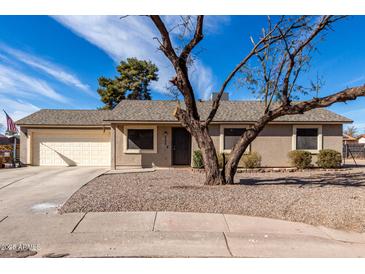 Charming single-story home featuring a low maintenance yard and attached two-car garage at 200 E Hess Ave, Coolidge, AZ 85128