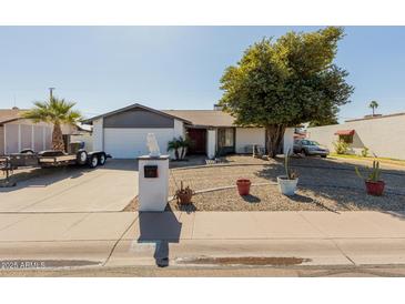 Charming single-story home featuring desert landscaping and a well-maintained front yard at 2143 W Eugie Ave, Phoenix, AZ 85029