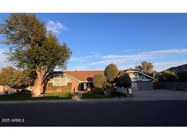 Charming single-story home featuring a well-manicured lawn and a two-car garage at 2237 N Kachina --, Mesa, AZ 85203