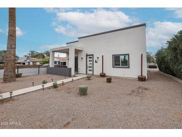 Charming home with a modern facade, well-maintained landscaping, and inviting front porch at 2246 E Sheridan St, Phoenix, AZ 85006