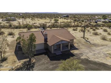 A beautiful, cozy home with a red tile roof sits on a large lot at 27141 E Javelina Dr, Florence, AZ 85132