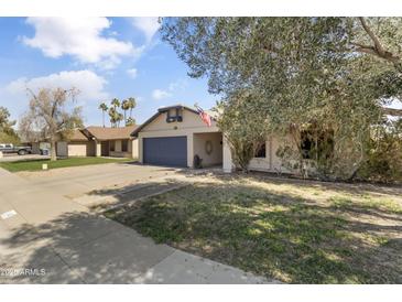 Charming single-story home with a well-maintained front yard and attached two car garage at 45 S Rita Ln, Chandler, AZ 85226