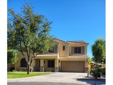 Charming two-story home featuring a well-maintained front yard, manicured lawn, and a two-car garage at 4529 S Granite St, Gilbert, AZ 85297