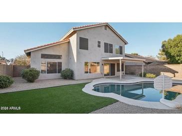 A beautiful backyard with a pool and grass at 7270 W Tina Ln, Glendale, AZ 85310