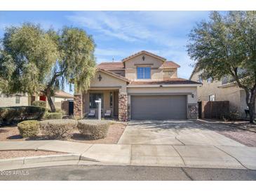 Charming two-story home with meticulously landscaped front yard at 7703 S 68Th Dr, Laveen, AZ 85339