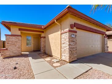 Charming single-story home featuring stone accents, a two-car garage, and a well-maintained front yard at 8250 S Hidden Trail Ct, Gold Canyon, AZ 85118